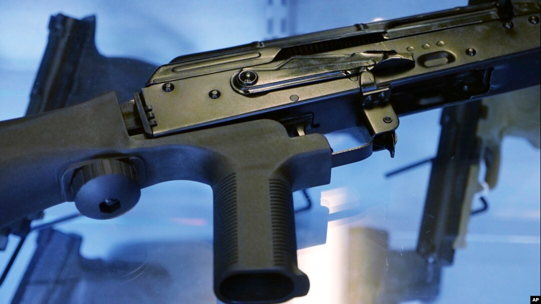 FILE - A little-known device called a "bump stock" is attached to a semi-automatic rifle at the Gun Vault store and shooting range, in South Jordan, Utah, Oct. 4, 2017. The device was used by Las Vegas shooter Stephen Paddock.
