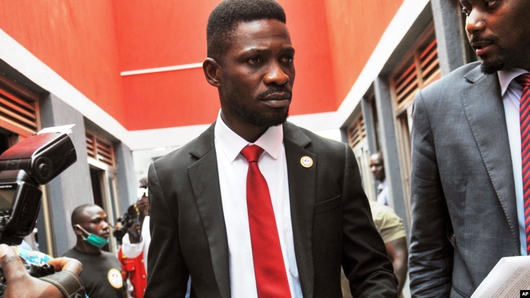 FILE - Bobi Wine, center, arrives to speak at the National Unity Platform head office in Kampala, Uganda, Aug. 31, 2020. Wine recently asked his followers on social media to financially support the party's parliamentary candidates. 