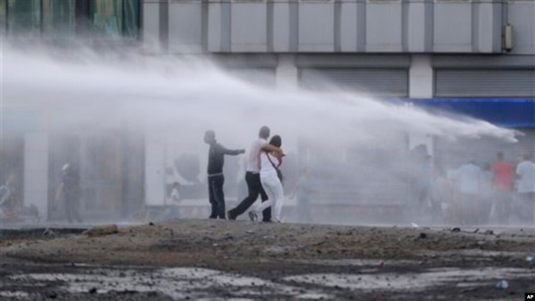Protesters are sprayed with water canon during clashes with riot police in Istanbul, Turkey, June 22, 2013