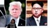 A woman walks by a huge screen showing U.S. President Donald Trump, left, and North Korea's leader Kim Jong Un, in Tokyo, March 9, 2018.