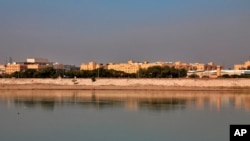 FILE - In this Jan. 3, 2020 file photo, the U.S. Embassy is seen from across the Tigris River in Baghdad, Iraq. At least three rockets targeted the U.S. Embassy in Baghdad's heavily fortified Green Zone on Dec. 20, 2020, Iraqi security officials said.