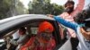 Sakshi Maharaj, an accused in the 1992 attack and demolition of a 16th century mosque, celebrates as he leaves a court in Lucknow, India, Sept. 30, 2020. 