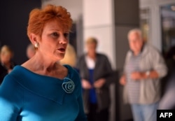 FILE - One Nation Party founder and Senate candidate Pauline Hanson (L) is pictured as she campaigns at a shopping arcade in the suburbs of Sydney on August 14, 2013.