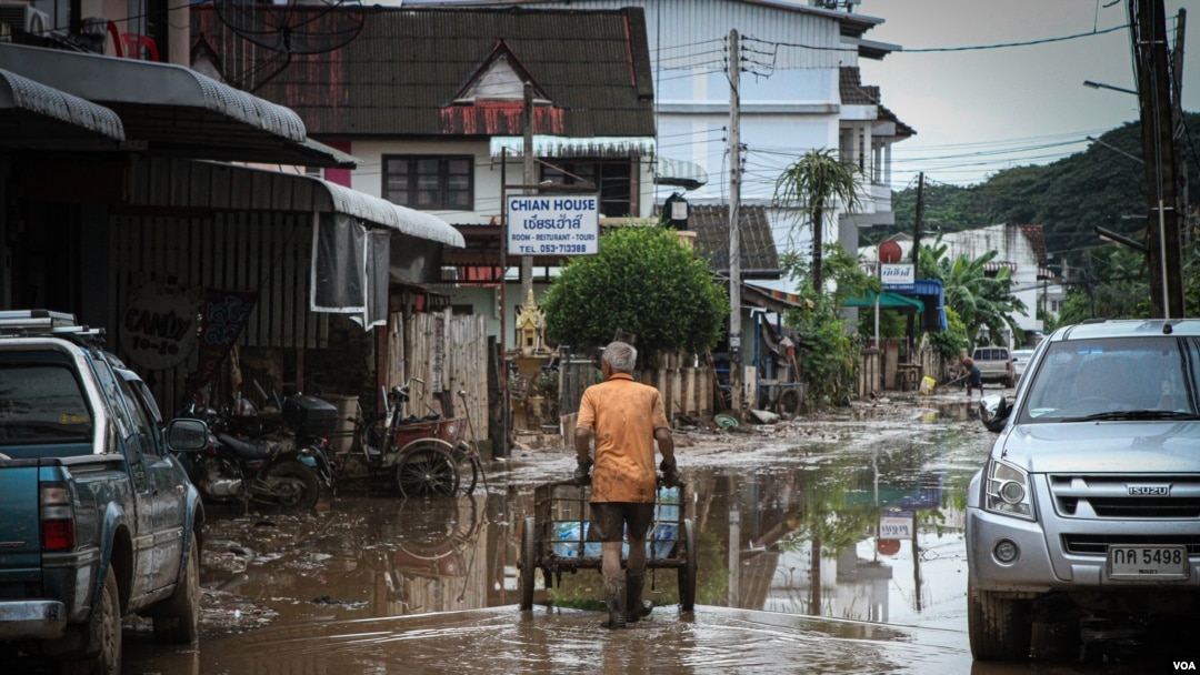 A man pushes bottles of clean water through the flooded areas in Chiang Rai, Thailand, Sept. 22, 2024.
