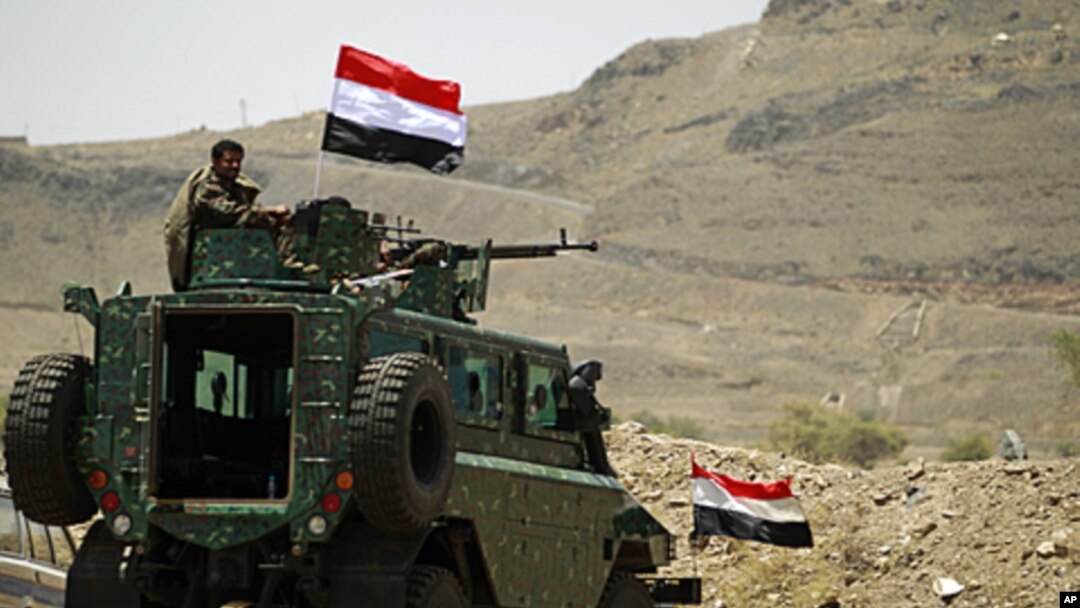 A police trooper mans a machine gun atop an armored personnel carrier near the Presidential Palace in Sana'a, Syria, May 13, 2011