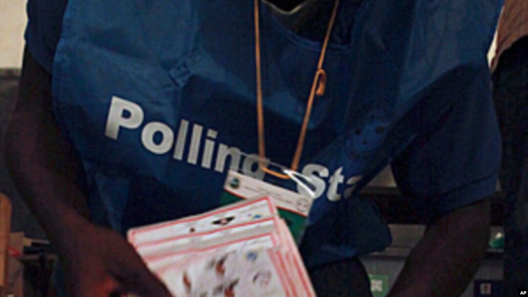 Polling agents count ballots for the Liberian presidential election at a polling station in Monrovia, October 11, 2011.