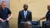 Charles Ble Goude of Ivory Coast enters the courtroom of the International Criminal Court (ICC) for his initial appearance in The Hague, Netherlands, March 27, 2014.