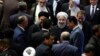 Iran's President Hasan Rouhani, center, leaves the parliament at the end of his swearing-in ceremony for the second term in office, in Tehran, Iran, Saturday, Aug. 5, 2017.