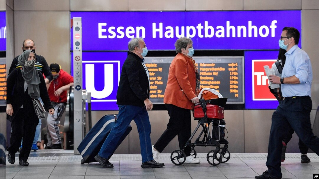 Passengers wear mandatory face masks at the main train station in Essen, Germany, Aug. 24, 2020. 