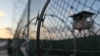 FILE - The sun rises over the Guantanamo detention facility at the Guantanamo Bay U.S. Naval Base, Cuba, May 13, 2009.