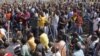 Striking mine workers armed with machetes, sticks, and spears march to a smelter plant at the Lonmin Platinum Mine near Rustenburg to hand over a memorandum to mine management and to ensure that workers had not reported for duty, Sept, 12, 2012.