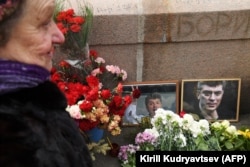 RUSSIA --An elderly woman lays flowers at the site where late opposition leader Boris Nemtsov was fatally shot on a bridge near the Kremli, in central Moscow, February 27, 2019