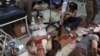 Wounded men receive treatment at a local clinic after airstrikes hit in Aleppo, Syria, Sept. 24, 2016. 