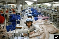 FILE - North Korean workers assemble jackets at a factory of a South Korean-owned company at the jointly run Kaesong Industrial Complex in Kaesong, North Korea, Dec. 19, 2013.