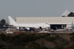 A plane carrying evacuees from the virus zone in China arrives at Marine Corps Air Station Miramar, Feb. 5, 2020, in San Diego, California.