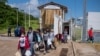 FILE - Deported migrants enter El Ceibo, Guatemala, on the border with Mexico, Aug. 12, 2021. The migrants, mostly Central Americans, were detained in southern Mexico as they were trying to reach the United States.