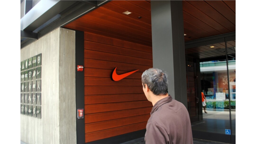FILE - A man passes a Nike store in Los Angeles, California. (Photo by Diaa Bekheet)