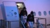 FILE - Australian evacuees who were quarantined on Christmas Island over concerns about the coronavirus disembark from a plane at Sydney Airport in Sydney, Australia, Feb. 17, 2020. 