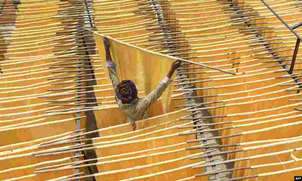 A Pakistani man dries Seviiyan (thin vermicelli), which is used for the preparation of 'sheerkhurma', a traditional sweet dish prepared by the Muslim community during the holy month of Ramadan, at a factory in Lahore.
