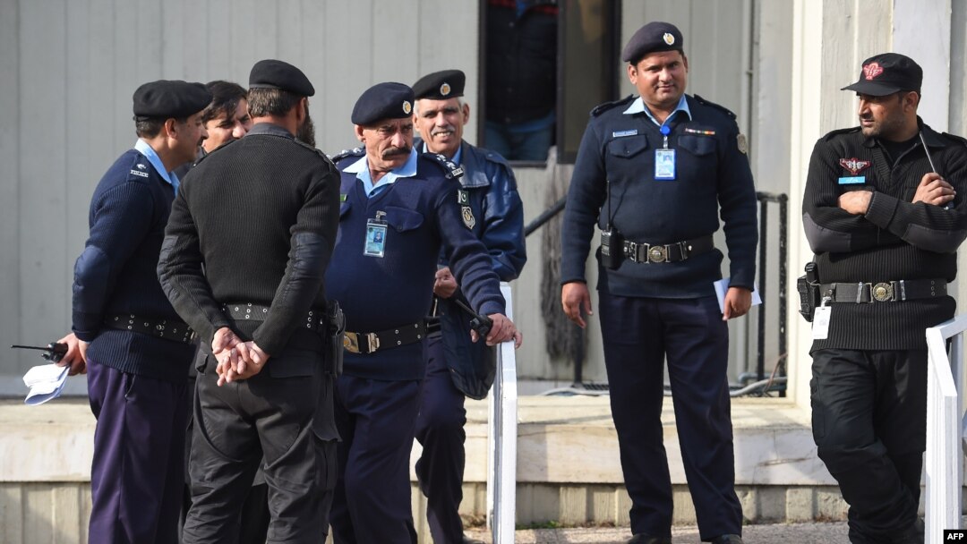 FILE - Pakistani policemen stand guard in front of the Supreme Court building during the court review appeal against a Pakistani Christian woman who spent eight years on death row for blasphemy, in Islamabad on Jan. 29, 2019.