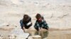 FILE - Displaced Yemeni girls are seen near a watercourse at a refugee camp located between Marib and Sanaa, Yemen, March 29, 2018.