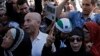 Muslims gather in front of the Paris Mosque after Friday prayers Sept. 26, 2014 to pay tribute to Herve Gourdel, a French mountain guide who was beheaded by an Algerian Islamist group, and to protest extremist tactics