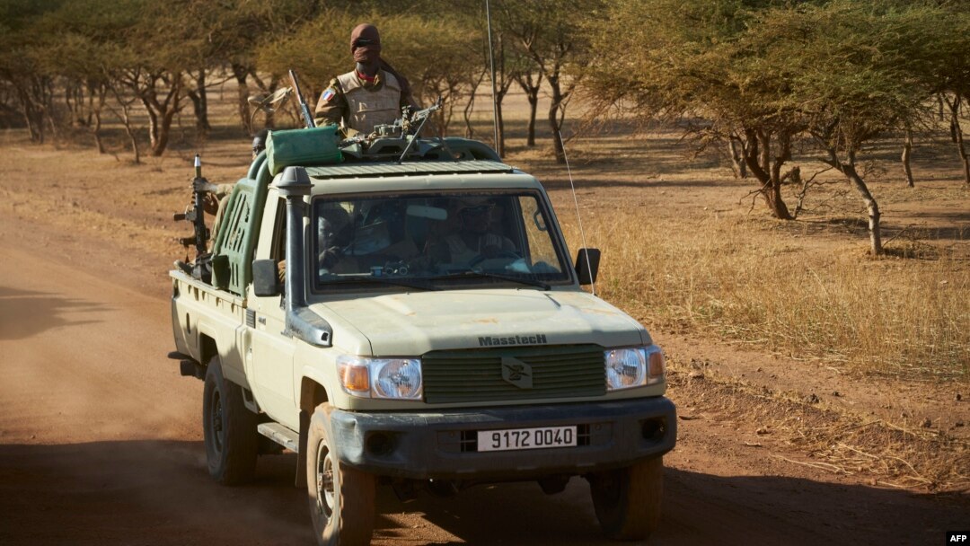 FILE - A vehicle of the Burkina Faso Army patrols a rural area in the Soum region in northern Burkina Faso, Nov. 14, 2019. At least 32 military police were killed in an attack on a military outpost in the area.
