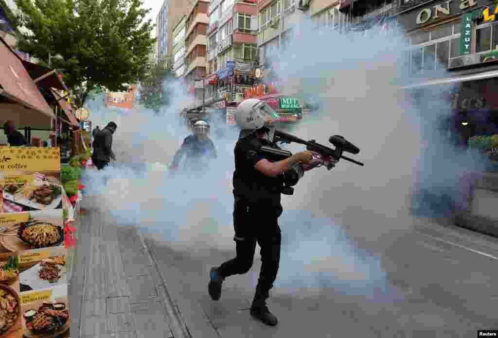 Riot police use tear gas to disperse demonstrators during a protest against the detention of two hunger-striking teachers in Ankara, Turkey.