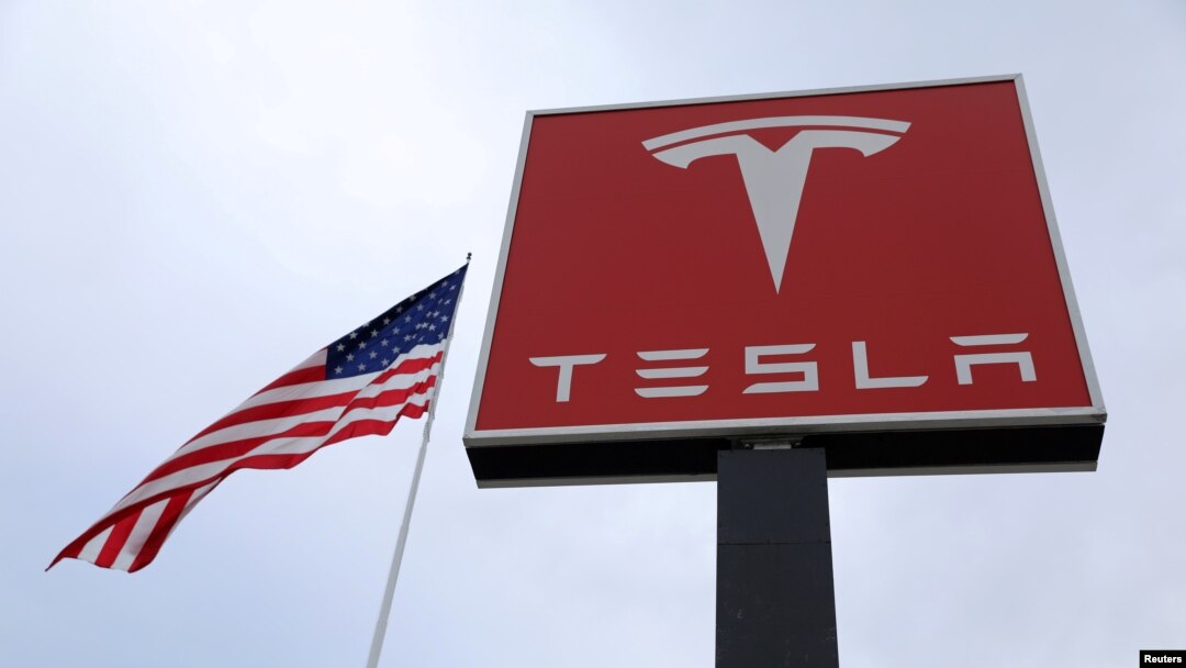 FILE - The Tesla logo is visible atop a charging station in Salt Lake City, Utah, Sept. 28, 2017.