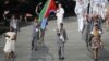Eritrea's flag bearer Weynay Ghebresilasie holds the national flag as he leads the contingent in the athletes parade during the opening ceremony of the London 2012 Olympic Games, July 27, 2012. 