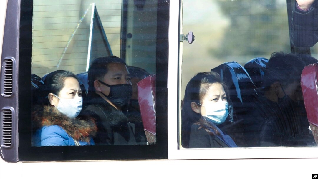 People wear masks as they ride on a public bus in Pyongyang, North Korea, Feb. 26, 2020. 