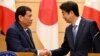 Philippines President Rodrigo Duterte shakes hands with Japanese Prime Minister Shinzo Abe at the end of their signing ceremony and joint remarks at Abe's official residence in Tokyo, Oct. 30, 2017.