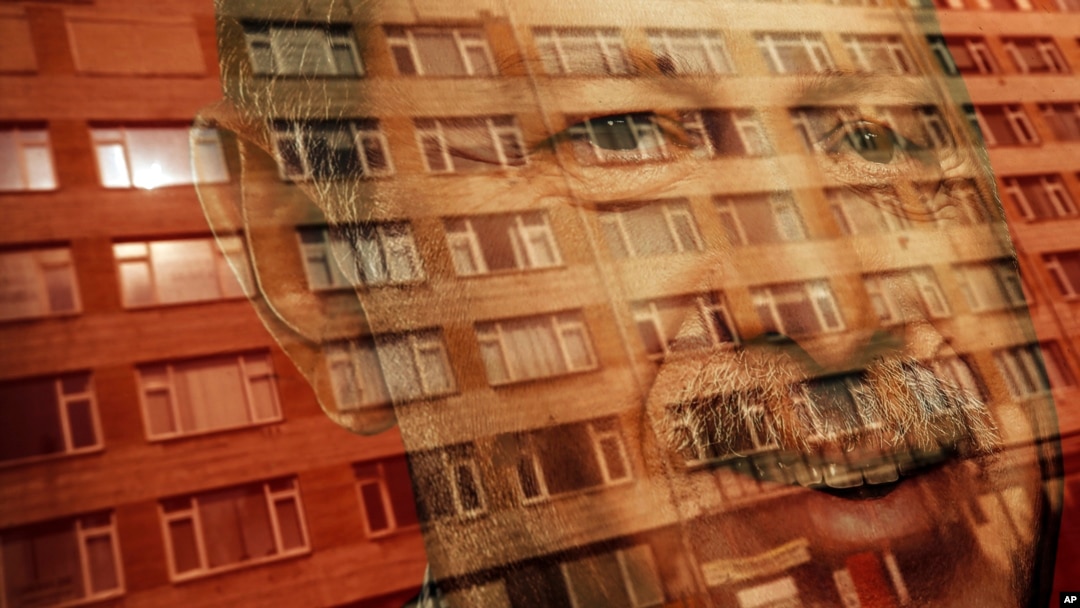 A building is reflected onto a poster of Turkey's President Recep Tayyip Erdogan, decorating a bus stop in Istanbul, June 15, 2018. Turkey holds parliamentary and presidential elections on June 24, 2018.