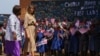 First lady Melania Trump is escorted by head teacher Maureen Masi as she arrives for a visits Chipala Primary School, in Lilongwe, Malawi, Oct. 4, 2018. 