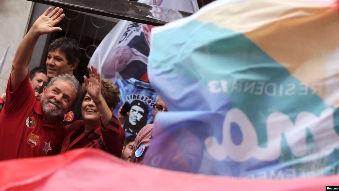 Brazil's President and Workers' Party (PT) presidential candidate Dilma Rousseff (R) and her predecessor Luiz Inacio Lula da Silva wave to supporters during a campaign rally in Sao Paulo, Oct. 3, 2014. 