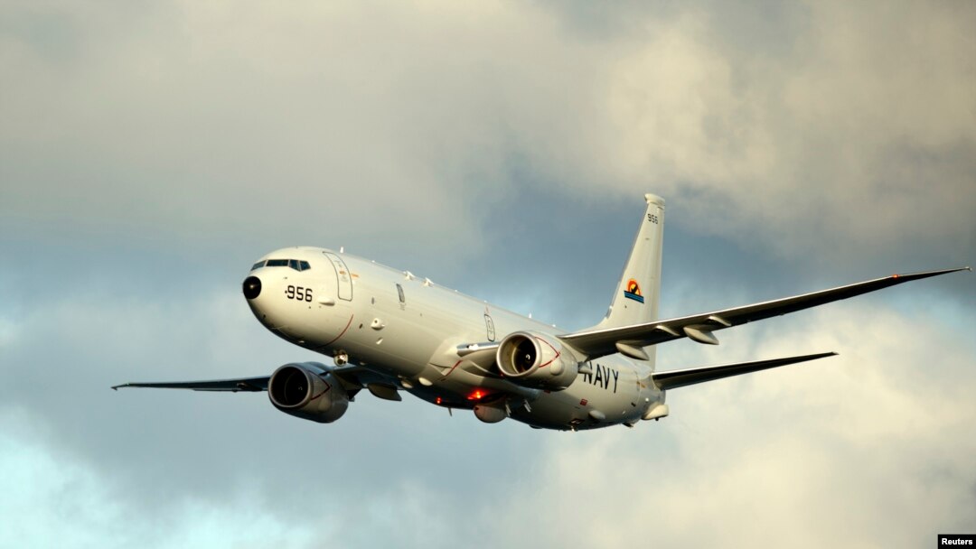 FILE - A P-8A Poseidon surveillance plane conducts flyovers above the Enterprise Carrier Strike Group in this handout photo courtesy of the U.S. Navy, Feb. 3, 2012.