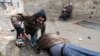 A Free Syrian Army fighter drags his comrade who was shot by sniper fire [and died soon after] during heavy fighting in the Ain Tarma neighborhood of Damascus, Syria, January 30, 2013.