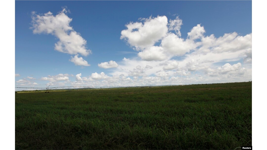 FILE - Clouds gather over state owned agriculture land near the village of Quivican, near Havana, Oct. 11, 2009.