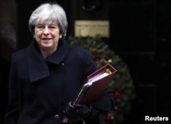Britain's Prime Minister Theresa May leaves 10 Downing Street in London, Dec. 13, 2017.