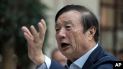 FILE - Ren Zhengfei, founder and CEO of Huawei, gestures during a meeting with reporters in Shenzhen city, south China's Guangdong province, Jan. 15, 2019.