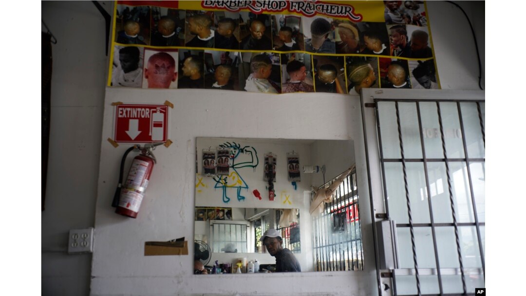 Haitian immigrant Kenson is pictured inside his barbershop in Tijuana, Mexico, Nov. 22, 2018.