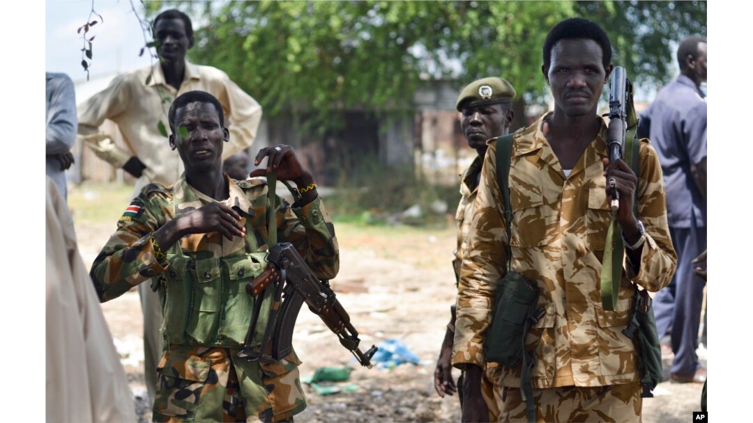 FILE - South Sudanese government soldiers patrol in Bentiu town, South Sudan, June 24, 2015.
