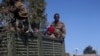 FILE - Ethiopian soldiers ride on a truck near the town of Adigrat, Tigray region, Ethiopia, March 18, 2021. 