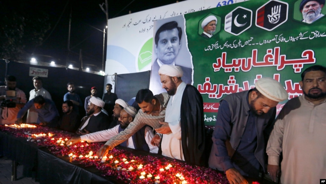 FILE - Members of the Shiite Ulema Council attend a candlelight vigil in Karachi, Pakistan, Oct. 29, 2022, for Pakistani journalist Arshad Sharif, killed by police near Nairobi, Kenya. 