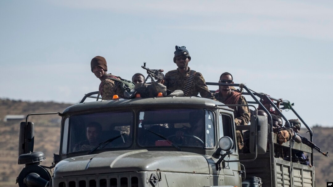 FILE - Ethiopian government soldiers ride in the back of a truck on a road near Agula, north of Mekele, in the Tigray region of northern Ethiopia, May 8, 2021. 