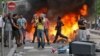 Rioters face riot police, following a pro-Palestinian demonstration, in Sarcelles, north of Paris, July 20, 2014. 