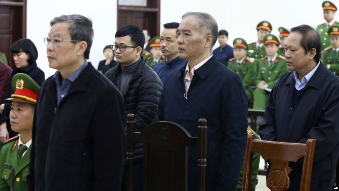 From left, Nguyen Bac Son, Hoang Duy Quang, Le Nam Tra and Truong Minh Tuan stand for the verdicts at their trial in Hanoi, Vietnam, Dec. 28, 2019. Son was sentenced to life in prison in a corruption case that saw the others receive lengthy prison time.