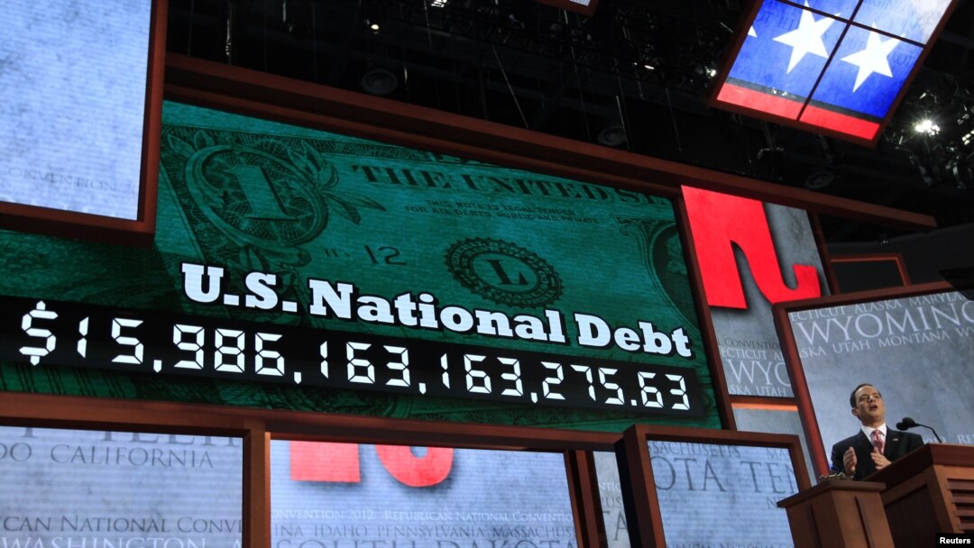 Republican National Committee Chairman Reince Priebus unveils a large U.S. national debt clock at the opening of the 2012 Republican National Convention in Tampa, Florida, August 27, 2012.