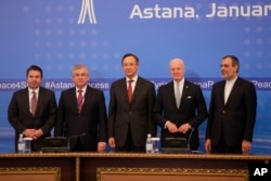 From left, Turkish Foreign Ministry Deputy Undersecretary Sedat Onal, Russia's special envoy on Syria Alexander Lavrentiev, Kazakh Foreign Minister Kairat Abdrakhmanov, UN Syria envoy Staffan de Mistura and Iran's Deputy Foreign Minister Hossein Jaber Ansari pose for a photo following the talks on Syrian peace in Astana, Kazakhstan, Jan. 24, 2017.