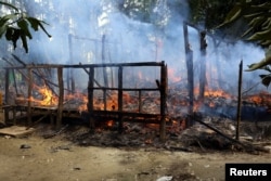 A house is seen on fire in Gawduthar village, Maungdaw township, in the north of Rakhine state, Myanmar, Sept. 7, 2017.